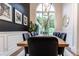 Bright dining room featuring a wood table, modern lighting, and large windows at 11911 W Grandview Dr, Columbus, IN 47201