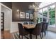 Elegant dining room featuring modern decor, a statement chandelier, and abundant natural light from large windows at 11911 W Grandview Dr, Columbus, IN 47201