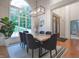 Dining room with large arched window, wood table, and black upholstered chairs at 11911 W Grandview Dr, Columbus, IN 47201