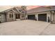 Beautiful stone and siding home featuring a spacious driveway and a three-car garage at 11911 W Grandview Dr, Columbus, IN 47201