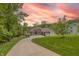 Long driveway leads to a beautiful house surrounded by lush greenery with a three-car garage at 11911 W Grandview Dr, Columbus, IN 47201