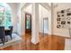 Spacious foyer with hardwood floors, featuring decorative columns and views into the dining room and living area at 11911 W Grandview Dr, Columbus, IN 47201