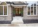 Elegant front entrance with stone accents, a double door entry, and manicured landscaping at 11911 W Grandview Dr, Columbus, IN 47201