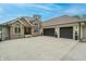 Stately stone and siding home featuring a three-car garage and well-manicured landscaping at 11911 W Grandview Dr, Columbus, IN 47201