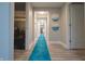 Bright hallway with a blue runner, light walls, and modern artwork at 11911 W Grandview Dr, Columbus, IN 47201