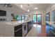 Bright kitchen featuring waterfall island, modern appliances, and sliding doors to outdoor space at 11911 W Grandview Dr, Columbus, IN 47201