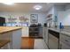 An open kitchen with stainless steel appliances, double oven, gray countertops, and tiled floors at 11911 W Grandview Dr, Columbus, IN 47201