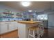Well-lit kitchen features a butcher block island, floating liquor shelves, and a cozy atmosphere at 11911 W Grandview Dr, Columbus, IN 47201