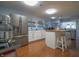 Spacious kitchen with stainless steel appliances, island with seating, and tiled floors at 11911 W Grandview Dr, Columbus, IN 47201