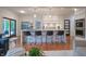 Open-concept kitchen with bar seating, modern appliances, and hardwood floors at 11911 W Grandview Dr, Columbus, IN 47201