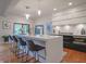 Bright kitchen with island seating, stainless steel appliances, and stylish pendant lighting at 11911 W Grandview Dr, Columbus, IN 47201