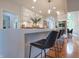 Spacious kitchen with white cabinetry and bar stool seating at 11911 W Grandview Dr, Columbus, IN 47201
