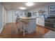 An open kitchen with wood countertop island with seating, double oven, and tiled floor at 11911 W Grandview Dr, Columbus, IN 47201