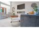Bright living room with modern fireplace, mounted TV, stylish furniture, and plush white carpet at 11911 W Grandview Dr, Columbus, IN 47201