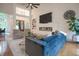 Comfortable living room featuring a modern fireplace, large TV, and views of the foyer and dining area at 11911 W Grandview Dr, Columbus, IN 47201
