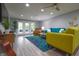 Open living room with ceiling fan, recessed lighting, french doors, and modern colorful furniture at 11911 W Grandview Dr, Columbus, IN 47201