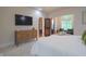 Bedroom with sitting area, tv, dresser and ensuite entrance at 11911 W Grandview Dr, Columbus, IN 47201