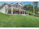 Expansive two-story deck with outdoor seating, ceiling fans, and string lights offers stunning outdoor living space at 11911 W Grandview Dr, Columbus, IN 47201