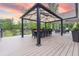 Outdoor dining area with seating for 10, gazebo covering, and views of the lake at 11911 W Grandview Dr, Columbus, IN 47201