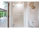 Bathroom featuring a walk-in shower and a toilet, designed for accessibility and modern living at 11911 W Grandview Dr, Columbus, IN 47201