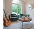 Bright sitting room with a large window, armchairs, guitar and stylish decor creating an inviting space at 11911 W Grandview Dr, Columbus, IN 47201