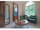 Cozy sitting room featuring a large window, two armchairs, guitar, and stylish decor creating an inviting space at 11911 W Grandview Dr, Columbus, IN 47201