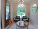 Cozy sitting room featuring a large window, two armchairs, and stylish decor creating an inviting space at 11911 W Grandview Dr, Columbus, IN 47201