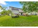 Spacious backyard with lush green grass, a fire pit, and a play structure at 12524 Trophy Dr, Fishers, IN 46038