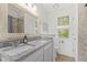 Bathroom with granite countertops, double sink vanity, and shower with tile surround at 12524 Trophy Dr, Fishers, IN 46038