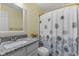 Bright bathroom featuring granite counters, modern fixtures, and a shower with patterned curtain at 12524 Trophy Dr, Fishers, IN 46038