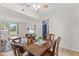 Open dining area with wood table, chairs, light fixture and connection to the living room at 12524 Trophy Dr, Fishers, IN 46038