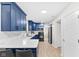 Modern kitchen featuring sleek blue cabinetry, white countertops, and stainless steel appliances at 12524 Trophy Dr, Fishers, IN 46038