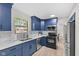 Modern kitchen featuring blue cabinets, stainless steel appliances, white countertops, and lots of natural light at 12524 Trophy Dr, Fishers, IN 46038