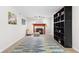 Bright living room with stylish rug, fireplace, modern lighting, and built-in shelving for storage or decor at 12524 Trophy Dr, Fishers, IN 46038