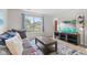 Comfortable living room featuring a gray sofa, blue and white rug, and a large TV at 12524 Trophy Dr, Fishers, IN 46038