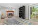 Cozy living room with a fireplace, sliding glass doors to a backyard patio and a decorative bookshelf at 12524 Trophy Dr, Fishers, IN 46038
