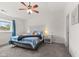 Bright bedroom with a ceiling fan, soft carpet, large windows and an accent wall headboard design at 12524 Trophy Dr, Fishers, IN 46038