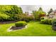 Well-manicured backyard with a lush green lawn and mature trees at 12539 Pebblepointe Pass, Carmel, IN 46033
