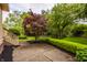 Landscaped backyard area featuring a concrete patio and lush green lawn at 12539 Pebblepointe Pass, Carmel, IN 46033