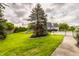 Expansive backyard featuring a well-maintained lawn, mature trees, and a fence for added privacy at 12539 Pebblepointe Pass, Carmel, IN 46033