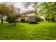 Beautiful backyard with a spacious lawn, mature trees, and a deck overlooking the serene surroundings at 12539 Pebblepointe Pass, Carmel, IN 46033