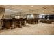 Finished basement boasts a bar area with seating and mirrored wall at 12539 Pebblepointe Pass, Carmel, IN 46033