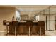 Basement bar with barstool seating and a mirrored wall at 12539 Pebblepointe Pass, Carmel, IN 46033