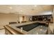 Basement bar featuring a microwave and seating area at 12539 Pebblepointe Pass, Carmel, IN 46033