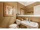 Well-lit half bathroom with framed art, decorative mirror and pedestal sink at 12539 Pebblepointe Pass, Carmel, IN 46033