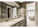 Bathroom boasting double sinks, granite countertops, and a large mirror, offering style and functionality at 12539 Pebblepointe Pass, Carmel, IN 46033