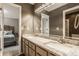 Bathroom boasting double sinks, granite countertops, and a large mirror, offering style and functionality at 12539 Pebblepointe Pass, Carmel, IN 46033