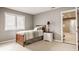 Comfortable bedroom showcasing neutral tones, a twin bed, and a window, creating a serene atmosphere at 12539 Pebblepointe Pass, Carmel, IN 46033