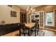 Elegant dining room with a modern chandelier, a spacious table, and a charming view through the French doors at 12539 Pebblepointe Pass, Carmel, IN 46033