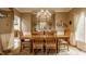 Formal dining room with elegant chandelier, wooden table and nautical decor, perfect for entertaining at 12539 Pebblepointe Pass, Carmel, IN 46033